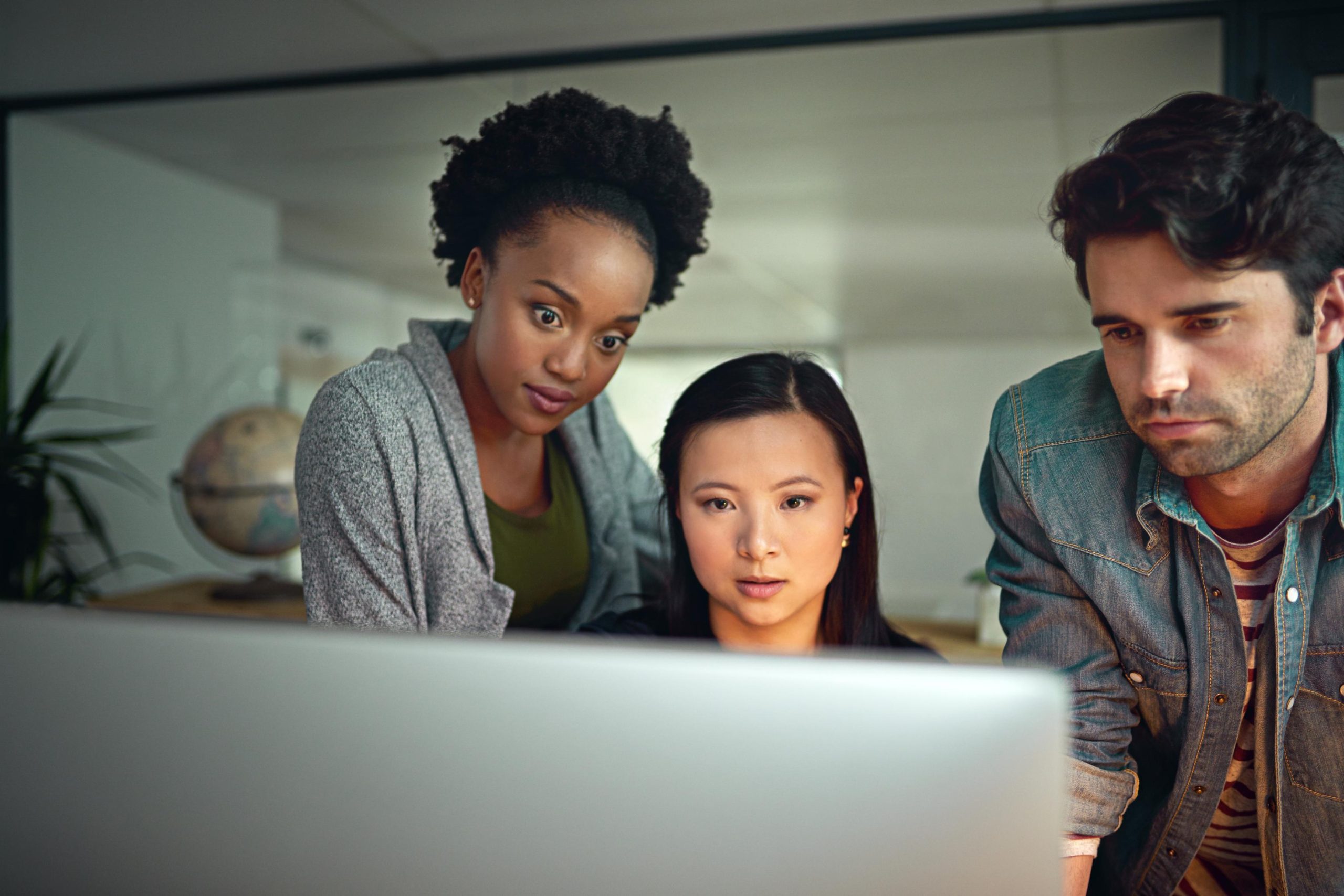 three accountants looking at new data sage 300 cre payroll report